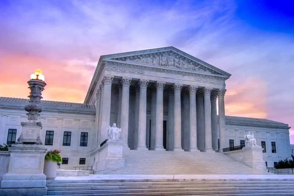 U.S. Supreme Court building in Washington, D.C. against purplish sunset light.